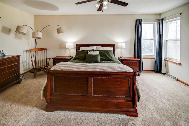 carpeted bedroom featuring visible vents, a ceiling fan, and baseboards