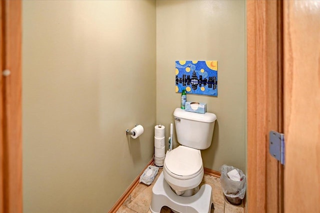 bathroom with tile patterned floors, baseboards, and toilet