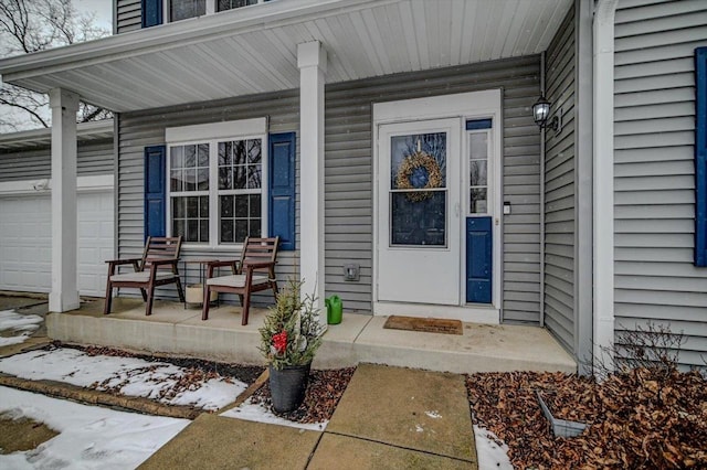 property entrance featuring a garage and a porch