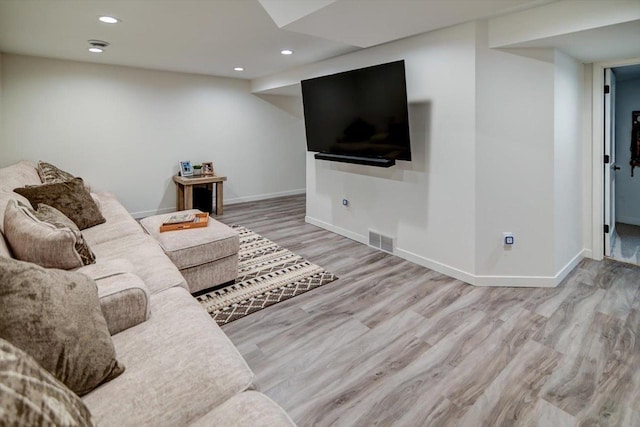 living area featuring recessed lighting, wood finished floors, visible vents, and baseboards