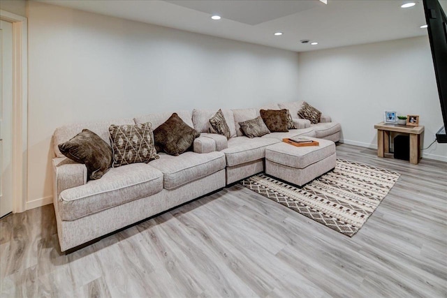 living room featuring recessed lighting, wood finished floors, and baseboards