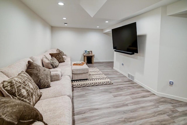 living area featuring recessed lighting, visible vents, baseboards, and wood finished floors