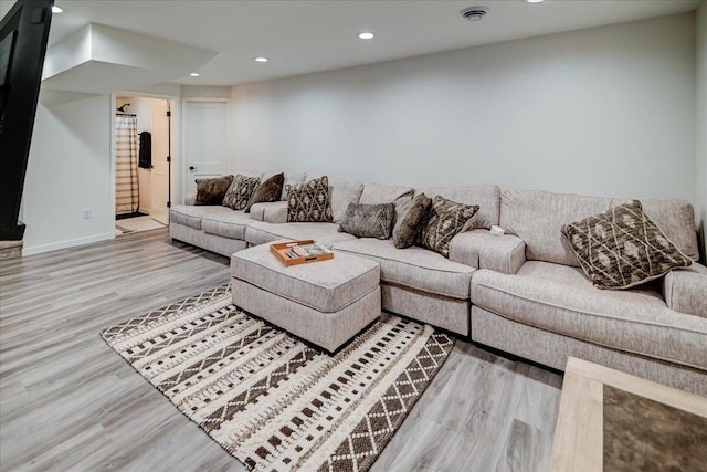 living area featuring recessed lighting, baseboards, and wood finished floors