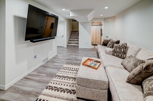 living area with visible vents, baseboards, stairs, recessed lighting, and wood finished floors