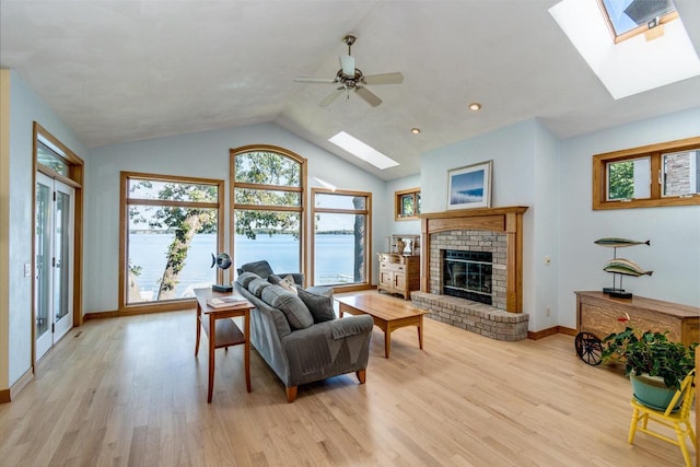 3018 Waubesa Ave, Madison, WI 53711 - living room with a skylight, healthy amount of natural light, vaulted ceiling, and light wood finished floors