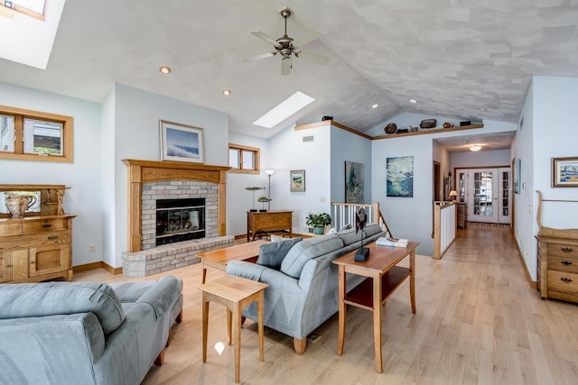 3018 Waubesa Ave, Madison, WI 53711 - living room with a skylight, light wood-type flooring, lofted ceiling, ceiling fan, and a fireplace