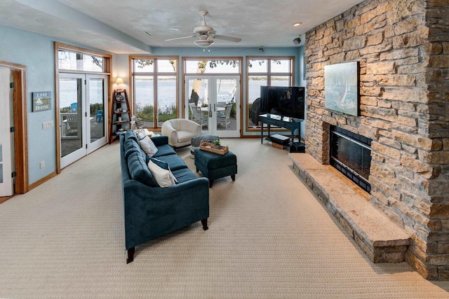 3018 Waubesa Ave, Madison, WI 53711 - living area with carpet flooring, ceiling fan, a stone fireplace, and plenty of natural light