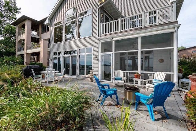 3018 Waubesa Ave, Madison, WI 53711 - back of house featuring an outdoor fire pit, a balcony, and a patio area