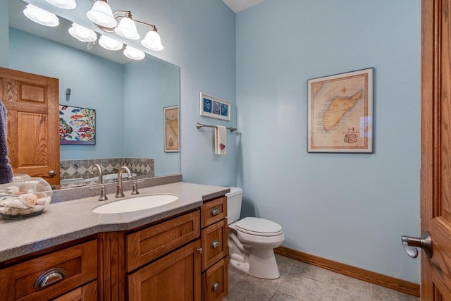 3018 Waubesa Ave, Madison, WI 53711 - bathroom featuring toilet, vanity, tile patterned flooring, and baseboards