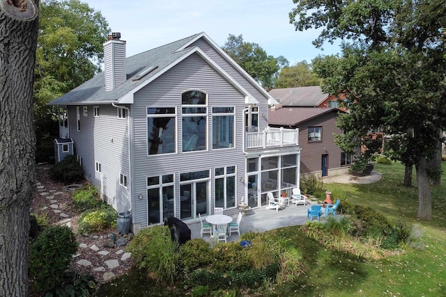 3018 Waubesa Ave, Madison, WI 53711 - rear view of property featuring a balcony, a patio, a chimney, a sunroom, and a lawn