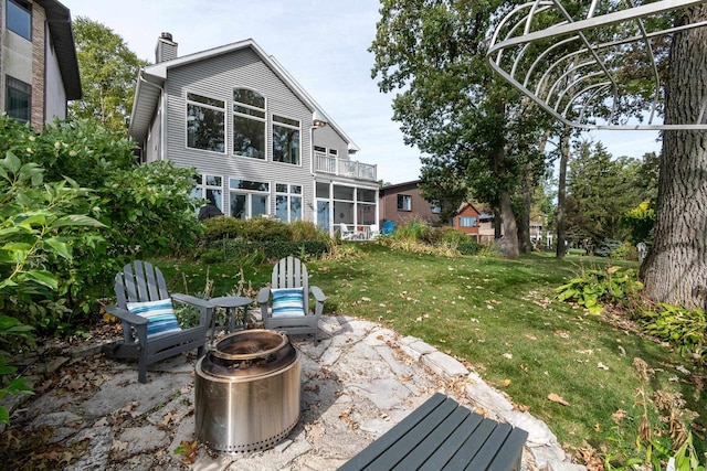 3018 Waubesa Ave, Madison, WI 53711 - view of grassy yard with an outdoor fire pit, a patio, and a balcony