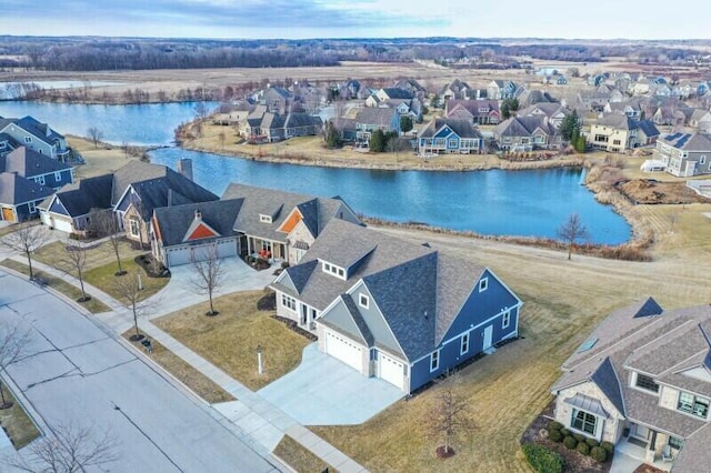 drone / aerial view with a residential view and a water view