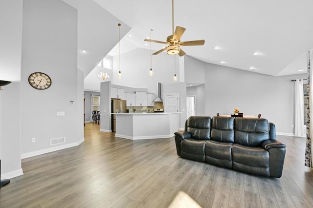 living area with visible vents, baseboards, recessed lighting, light wood-style flooring, and a ceiling fan