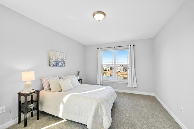 carpeted bedroom featuring baseboards