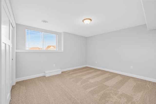 carpeted spare room with baseboards