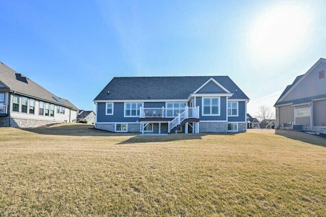 rear view of property featuring a yard and stairs