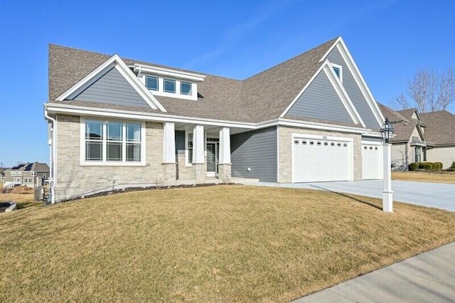 view of front facade featuring stone siding, roof with shingles, concrete driveway, and a front yard