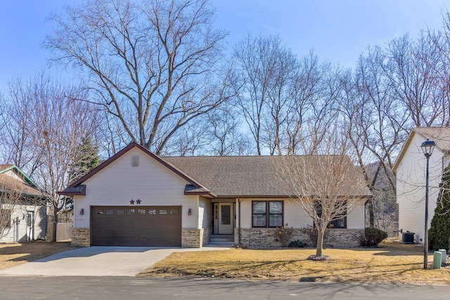 view of front of property featuring central AC, concrete driveway, an attached garage, a shingled roof, and brick siding