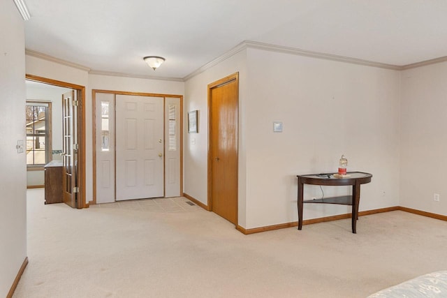 carpeted entrance foyer featuring baseboards and crown molding