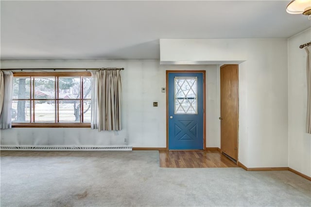 entrance foyer featuring a baseboard radiator, baseboards, and carpet flooring