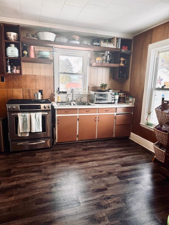 kitchen featuring gas stove, light countertops, open shelves, and a sink