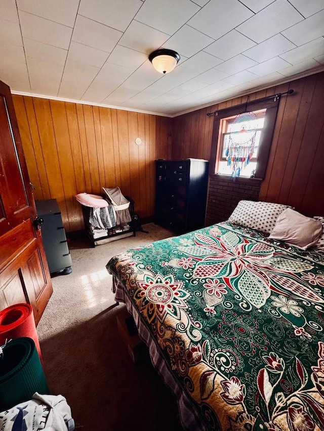 carpeted bedroom with wooden walls