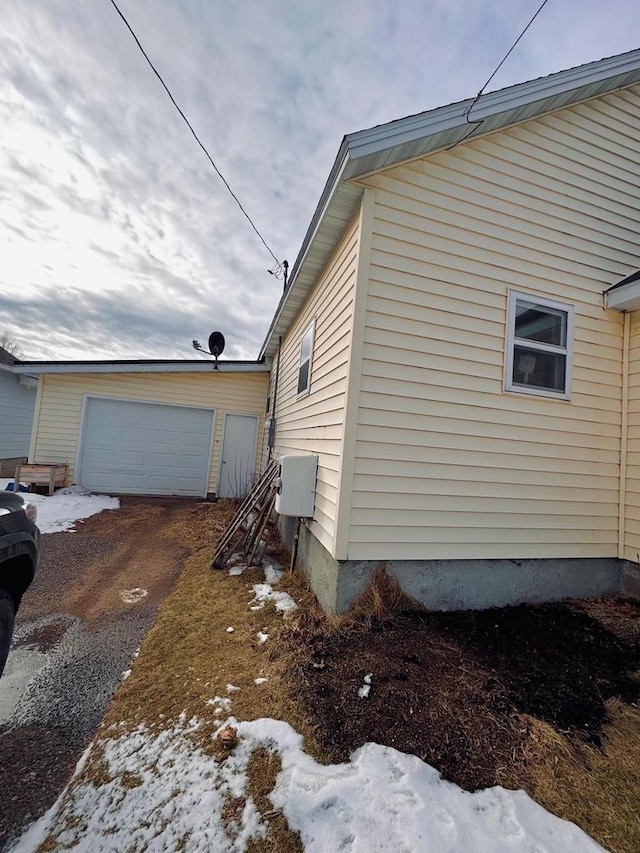 snow covered property featuring a garage