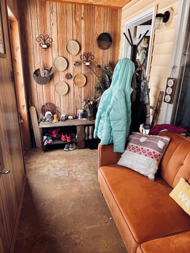 mudroom featuring wood walls