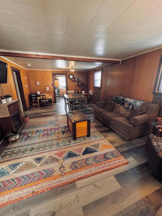 living room with wood finished floors and wood walls