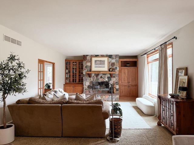 3951 Weatherwood Trl, Verona, WI 53593 - living area with a stone fireplace, visible vents, and light carpet