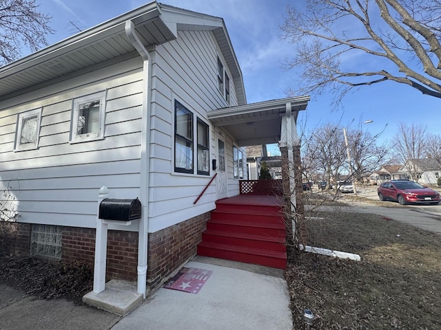 view of side of property featuring crawl space and a porch