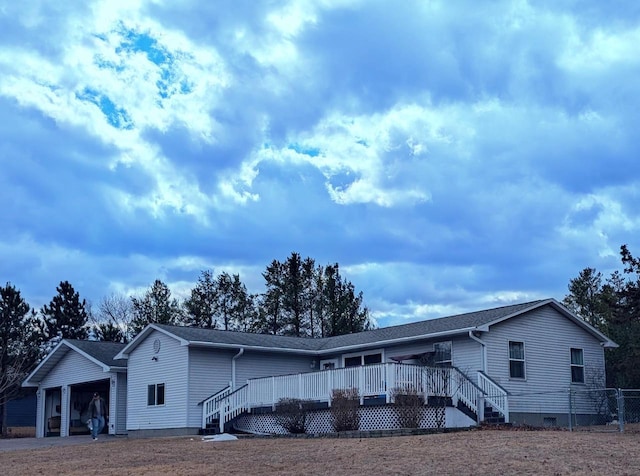 view of front facade featuring crawl space, a wooden deck, and a garage