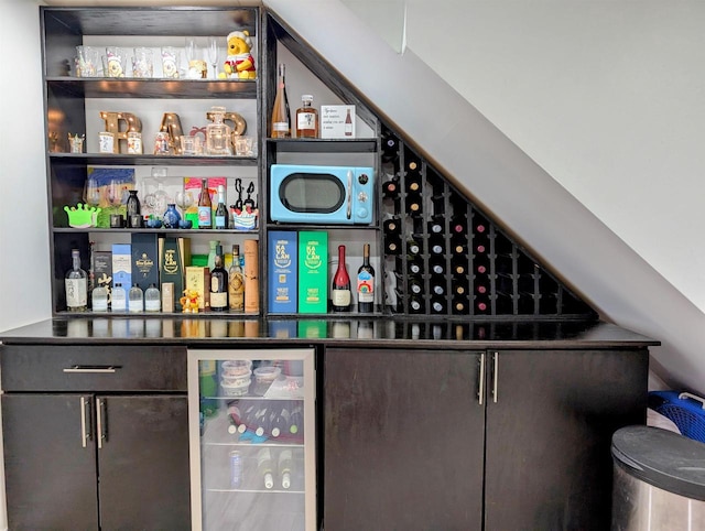 bar featuring wine cooler and a dry bar