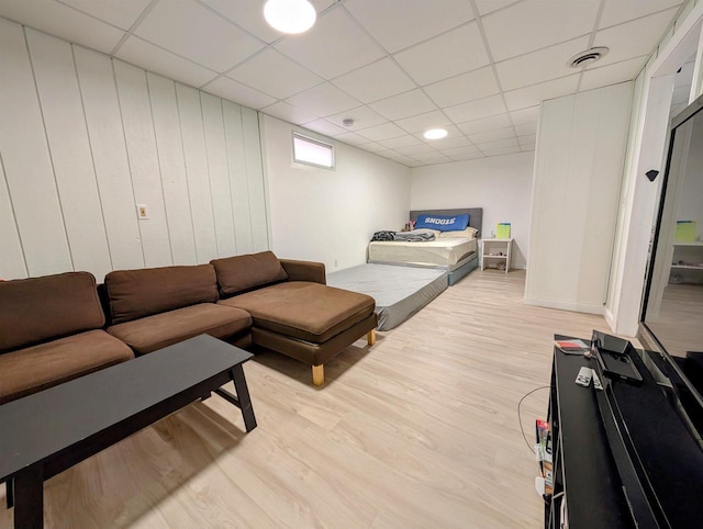 bedroom featuring visible vents, light wood-type flooring, and a paneled ceiling