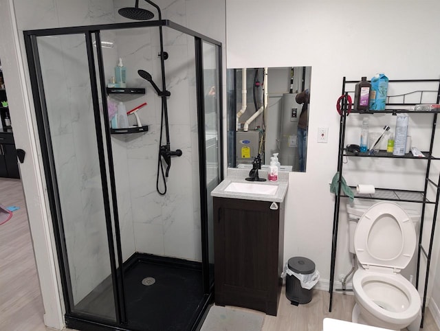 full bath featuring a marble finish shower, electric water heater, toilet, wood finished floors, and vanity