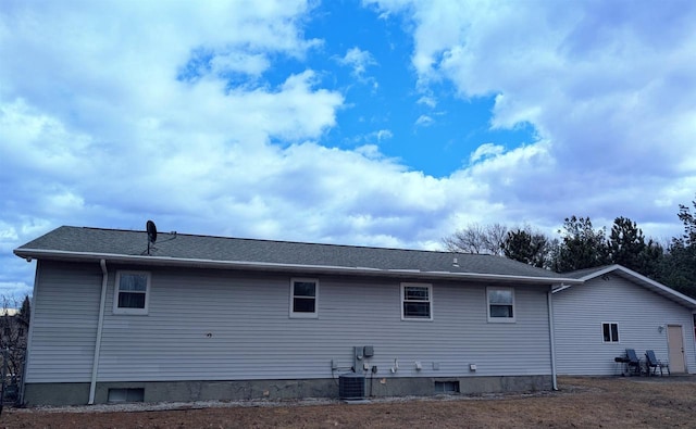 rear view of property featuring central AC unit