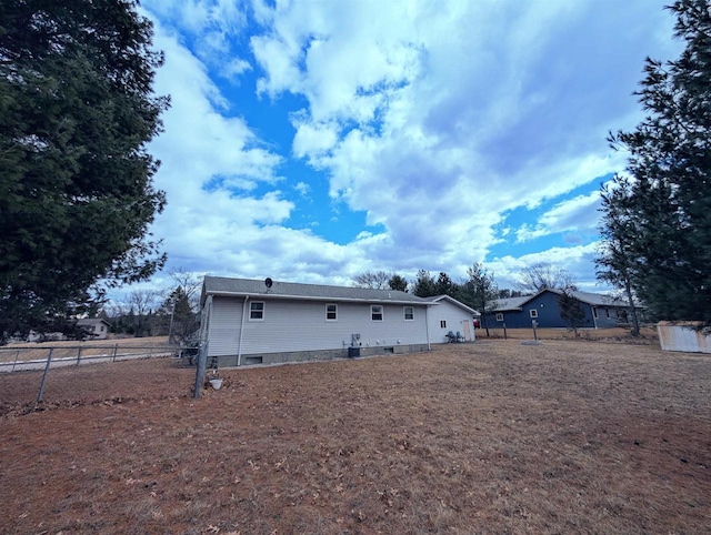 rear view of house featuring fence