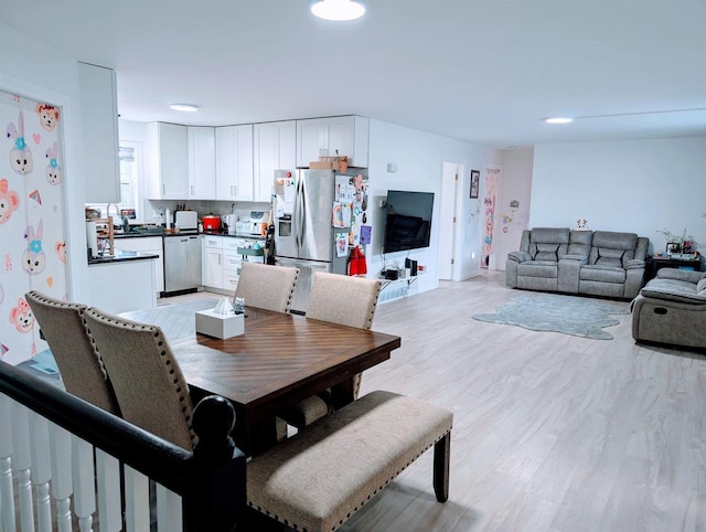 dining area with recessed lighting and light wood finished floors