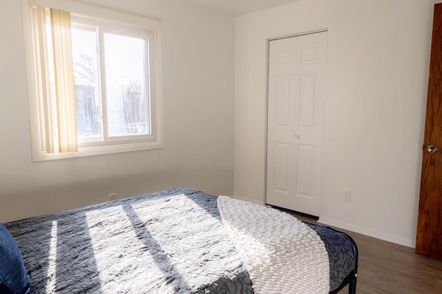 bedroom featuring wood finished floors and baseboards