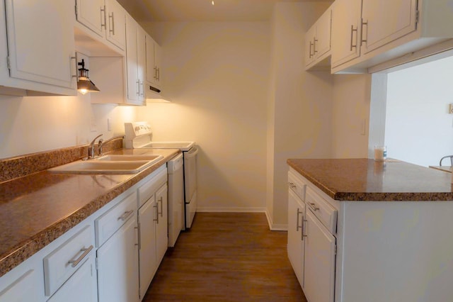 kitchen featuring a sink, electric range, baseboards, and white cabinetry