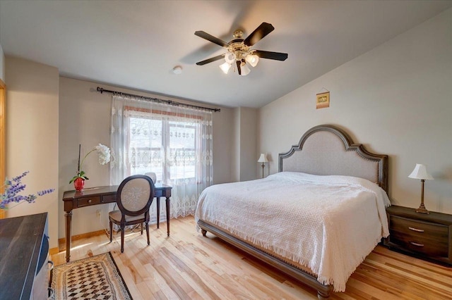 bedroom featuring light wood-style floors, ceiling fan, and vaulted ceiling