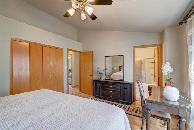 bedroom with a closet, light wood-type flooring, ceiling fan, and vaulted ceiling