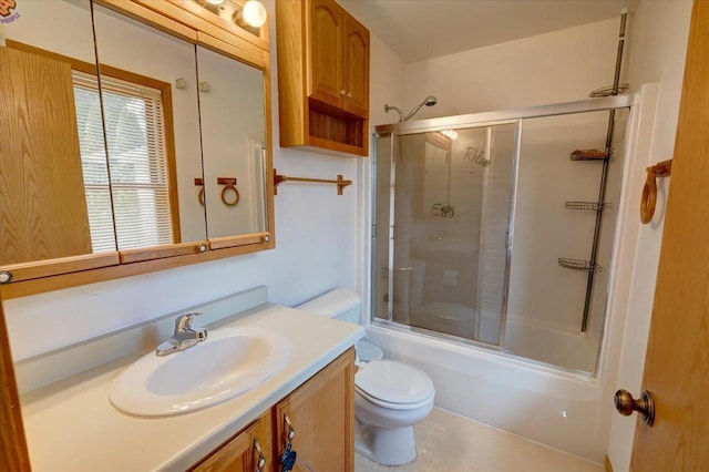 bathroom with enclosed tub / shower combo, toilet, and vanity