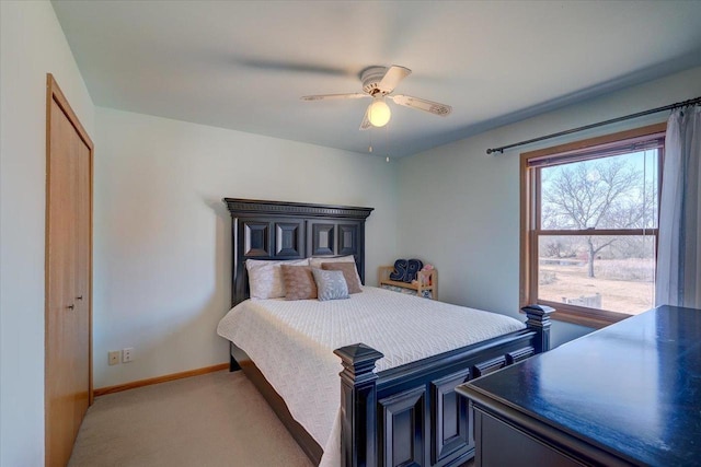 carpeted bedroom featuring baseboards, a closet, and ceiling fan