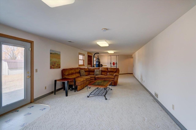 living room with visible vents, baseboards, and light carpet