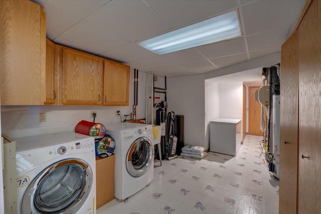 laundry room with cabinet space, light floors, and washing machine and clothes dryer