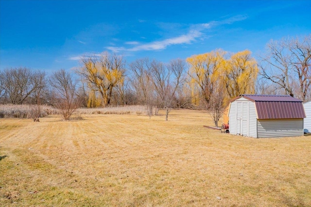 view of yard with an outbuilding and a storage shed