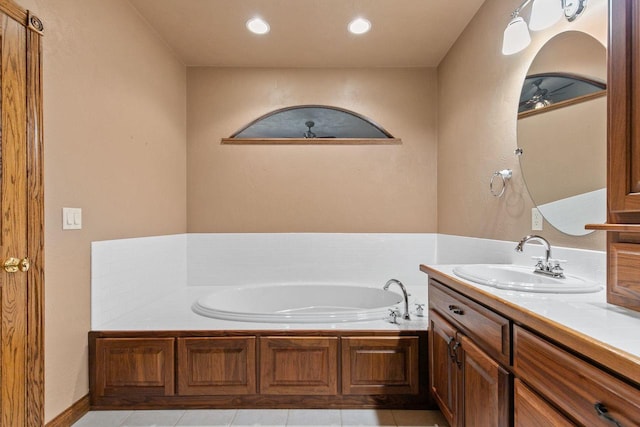 bathroom featuring a bath, recessed lighting, tile patterned floors, and vanity