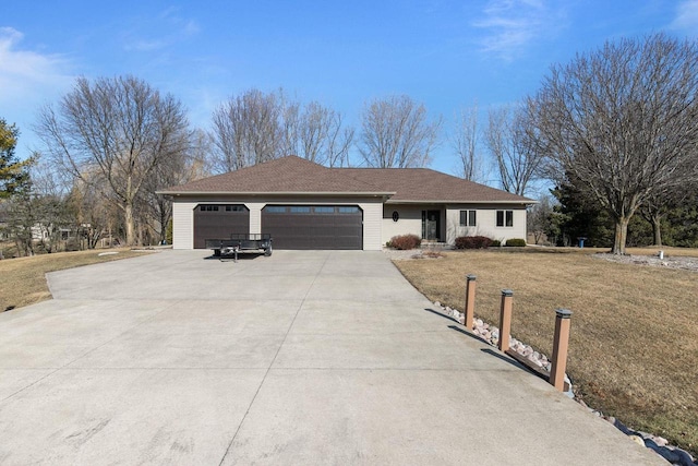 ranch-style house featuring an attached garage, driveway, and a front yard