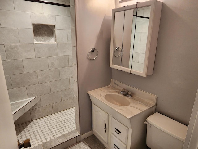 full bath featuring vanity, a shower stall, and toilet